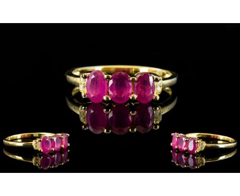 Ruby and White Topaz Ring, a trio of oval cut rubies, accented with small, round white topaz, totalling 1.75cts, set in gold 