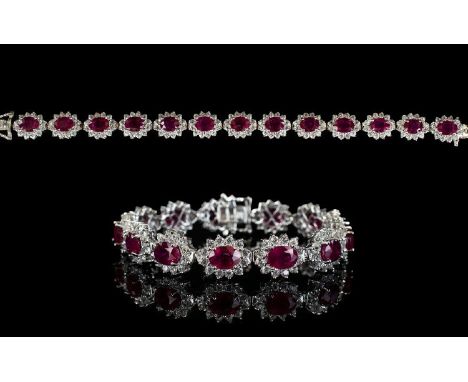 Ruby and Natural White Zircon Line Bracelet, 34cts of oval cut rubies framed with round cut natural white zircon, each rich r