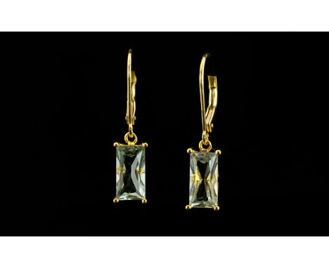 Green Amethyst Pair of Drop Earrings, each earring comprising an unusual 1.5ct baguette cut green amethyst suspended from a 1