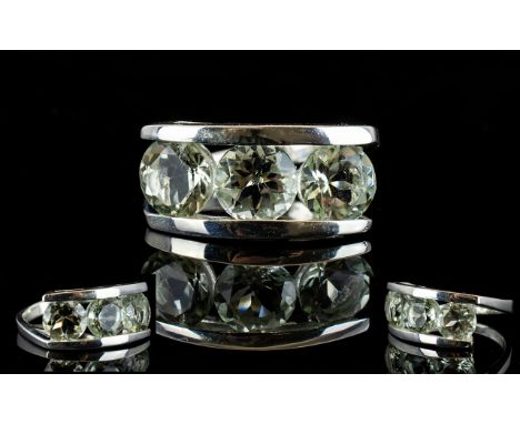 Brazilian Green Amethyst Contemporary Three Stone Ring, a trilogy of round cut green amethysts, totalling 5cts, with the appe