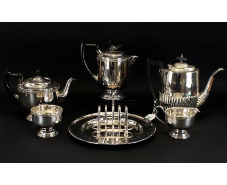 A Plated Metal Matched Tea And Coffee Service Of typical form, to include teapot, coffee pot, twin handle sugar bowl, tray, a