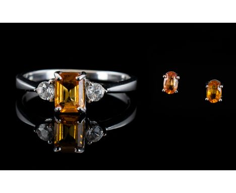 Orange Sapphire Ring and Pair of Stud Earrings, an octagon cut orange sapphire of 1ct, flanked by two round cut natural white