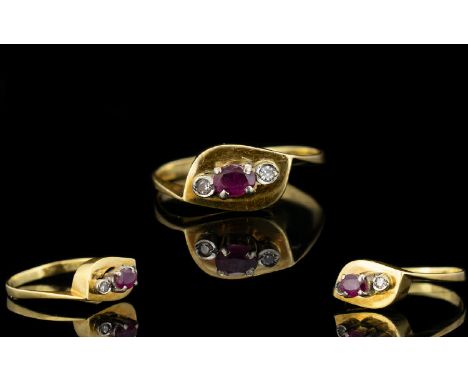 18ct Gold - Attractive Ruby and Diamond 3 Stone Dress Ring. The Central Ruby Flanked by Two Small Diamonds. Marked 750, Ring 