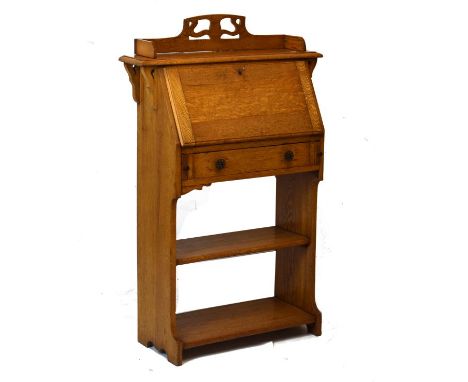 Edwardian lady's light oak bureau, the fall flap opening to reveal a partially fitted interior, one long drawer and two open 