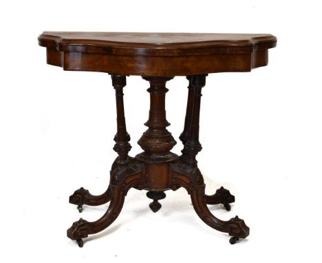Victorian walnut and figured walnut serpentine front fold-over card table standing on a turned pillar and quadripartite base 