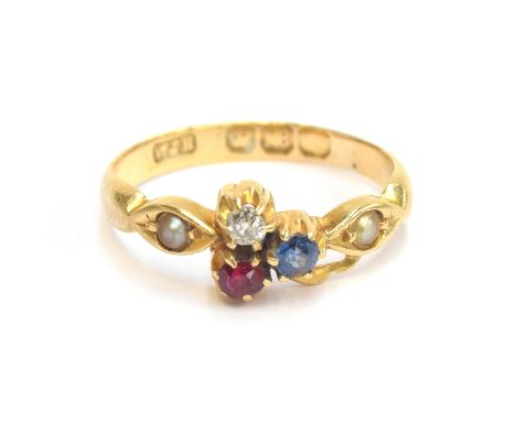 An Edwardian 18ct gold ring set with a diamond, ruby and sapphire clover, flanked by pearls, size J, 2.6g 