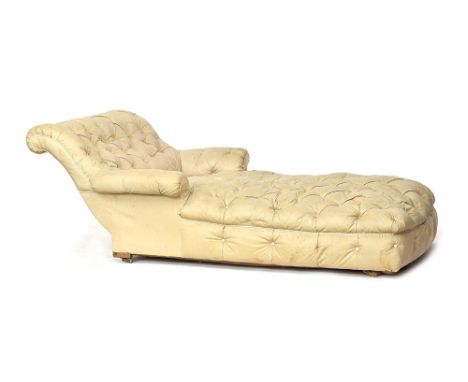 A Victorian button upholstered day bed of grand proportions with raked back and outswept arms, the legs later cut. 120cm wide