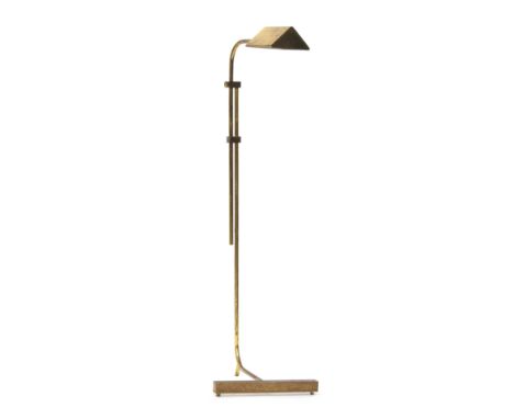 An adjustable brass reading lamp, on a cantilevered base