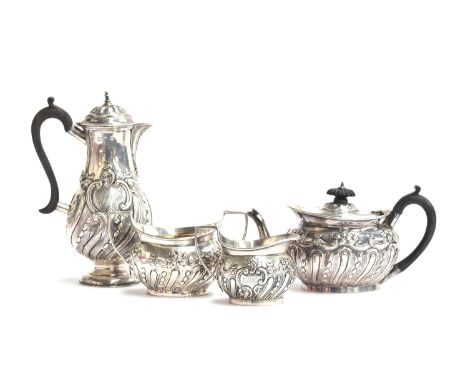 A late Victorian four piece tea and coffee set by Carrington &amp; Co., London 1897, each piece half gadrooned and chased wit