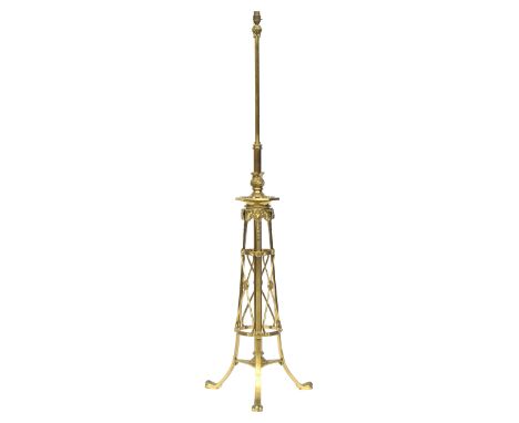 A heavy brass standard lamp, the legs capped with ram masks. approx. 150cm high 