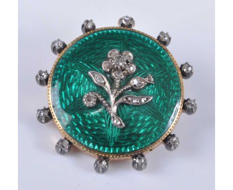 An early 20th century yellow metal guilloche enamel and diamond set pendant brooch, of circular form, having a green ground w
