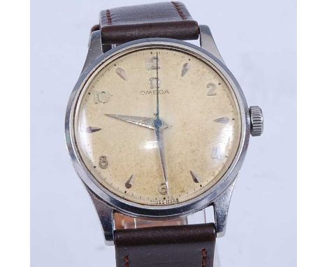 A vintage gent's Omega steel cased manual wind wristwatch, having a signed champagne dial (discoloured) with even Arabic nume