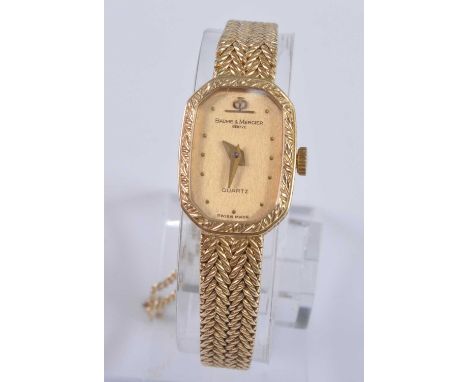 A Baume &amp; Mercier Geneve lady's 18ct gold cased quartz wristwatch, having signed tank dial with dot markers, back cover n