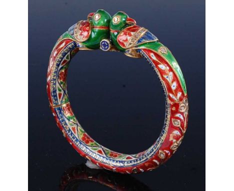 A late 19th century Indian Moghul yellow metal, diamond and enamelled hinged bangle, having concealed hinge at 9 o'clock, wit