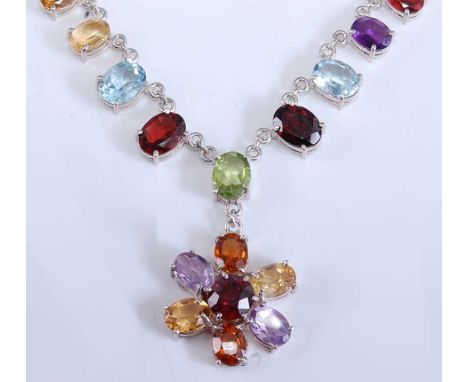 A sterling silver multi-stone fringe necklace, featuring a combination of garnet, amethyst, lemon quartz, citrine, peridot an