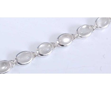A white metal moonstone bracelet, with fourteen oval cabochon cut moonstones, in bezel settings with bolt ring clasp, moonsto