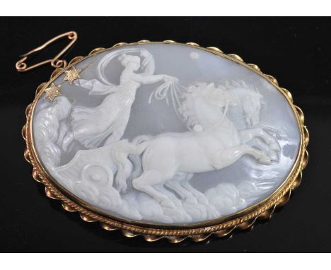 A continental carved shell cameo brooch depicting the Goddess of the Dawn Aurora / Eos upon her chariot, within a yellow meta
