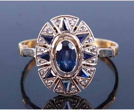 A yellow and white metal, sapphire and diamond oval cluster ring, featuring a centre oval faceted sapphire surrounded by eigh