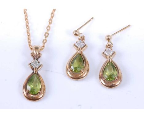 A yellow metal, peridot and topaz pendant and earring set, the earrings each with a pear cut peridot in a bezel setting suspe