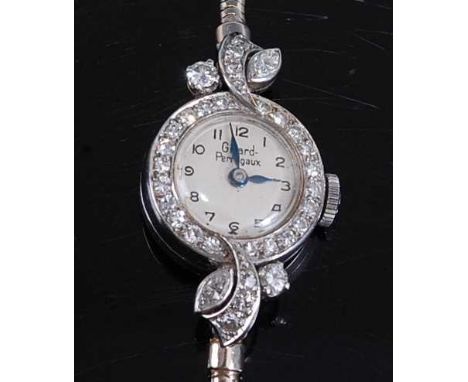 A 9ct white gold lady's Girard Peregaux diamond set manual wind cocktail watch, having a round silver Arabic dial bezel set w