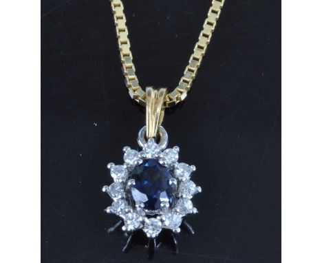 An 18ct yellow and white gold, sapphire and diamond flower head pendant, the claw set oval cut sapphire weighing approx 0.35 