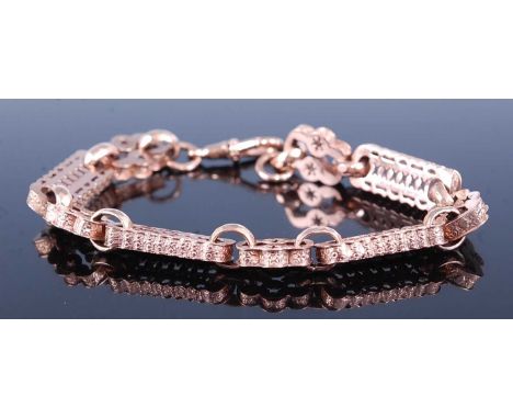 A rose metal fancy link bracelet, comprising alternating bar shaped and lozenge shaped links with pierced openwork detail ad 