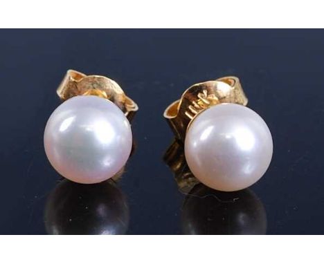 A pair of yellow metal cultured pearl stud earrings, each with a 7.3mm pearl and post and scroll fittings, pearls assessed as