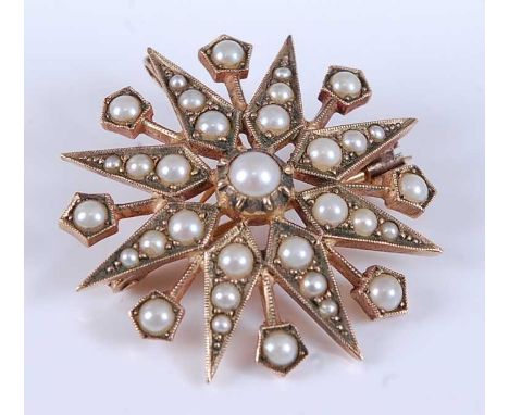 A 9ct yellow gold pearl eight-ray star brooch, featuring thirty-three 1.5 to 3.9mm seed pearls in grain settings, with a roll