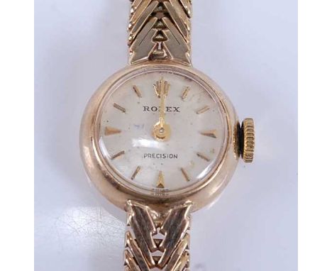 A 9ct yellow gold lady's Rolex Precision manual wind wristwatch, having round cream baton dial and integral chevron link brac