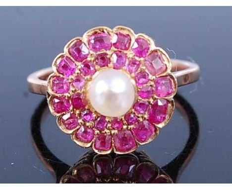 A rose metal, ruby and pearl circular cluster ring, comprising a centre 4.65mm cultured pearl within two borders of 12 and 15