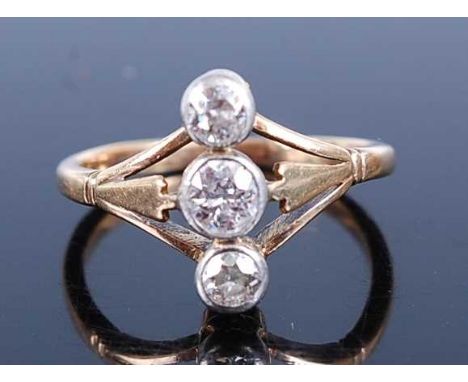 A yellow and white metal diamond three-stone ring, comprising three graduated Old European cut diamonds in bezel settings, wi