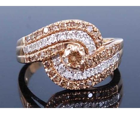 A 9ct yellow gold crossover diamond ring, featuring 33 fancy light brown and 20 single cut diamonds in claw and grain setting