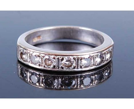 A white metal diamond half hoop eternity ring, featuring seven round brilliant cut diamonds in grain settings, diamond dimens