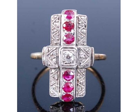 A yellow and white metal, ruby and diamond lozenge shaped panel cluster ring, featuring six round faceted rubies and twenty-n