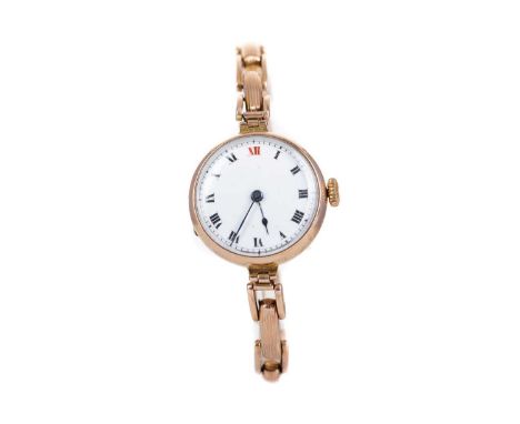 LADY'S NINE CARAT GOLD MANUAL WIND WRIST WATCH,the round white dial with Roman hour markers, outer railroad seconds track in 