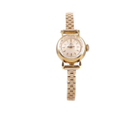 LADY'S OMEGA NINE CARAT GOLD MANUAL WIND WRIST WATCH,the round cream dial with baton hour markers, 16mm case, on a nine carat