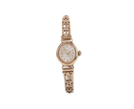LADY'S ACCURIST NINE CARAT GOLD MANUAL WIND WRIST WATCH,the cream dial with baton and Arabic hour markers, 14mm case, on a ga