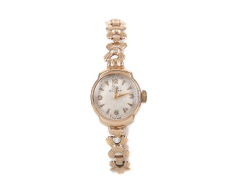LADY'S RECORD NINE CARAT GOLD MANUAL WIND WRIST WATCH,the round cream dial with Arabic and wedge hour markers, outer seconds 