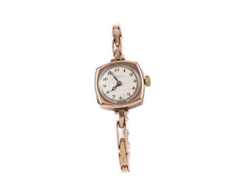LADY'S NINE CARAT GOLD MANUAL WIND WRIST WATCH,the round cream dial with Arabic hour markers, railroad outer seconds track in