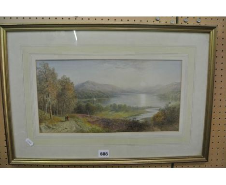A late 19th century watercolour of an extensive lakeland landscape at sunset with woman and child on a pathway to the foregro