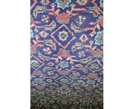 A Persian style wool runner with blue ground and multi-abstract floral detail within running borders, 320 x 115 cm 