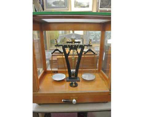 A set of Stanton instrument beam scales set within a polished teakwood and glass cabinet to weigh 7lbs, number 5517, engraved