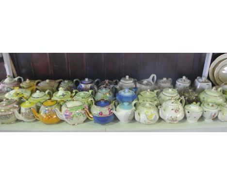 An extensive collection of various decorative teapots, mainly in the Art Deco manner, with various moulded and painted floral