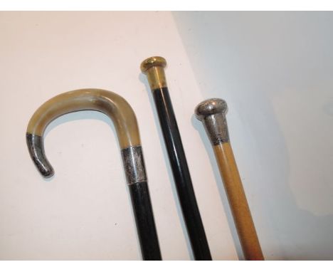 An ebonised walking cane of slender tapering form terminating in a mushroom shaped brass cap with chased decoration, 87 cm ta