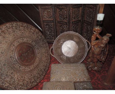 A collection of Indian and Cashmere carved timber ware including circular table with folding frame, three various cigar boxes