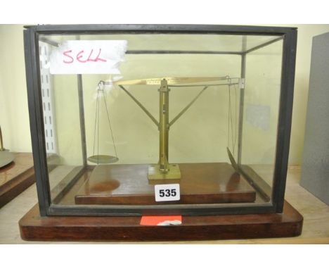 A Victorian beam scale to light/heavy wight, half oz set in a mahogany brass and glass cabinet, City of Bristol by Bate of Lo