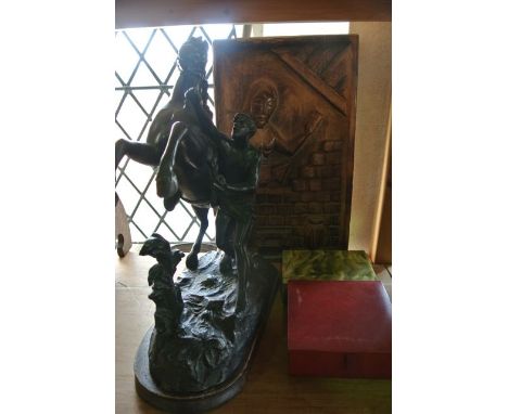 A spelter figure depicting a rearing horse toiling with a standing male figure together with an unusual carved timber panel o