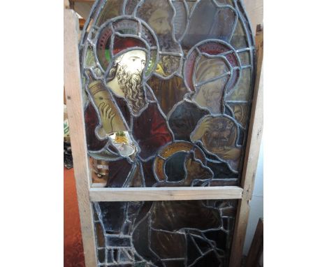 A 19th century stained glass and leaded lancet shaped panel/window depicting a biblical scene of four male figures carrying s