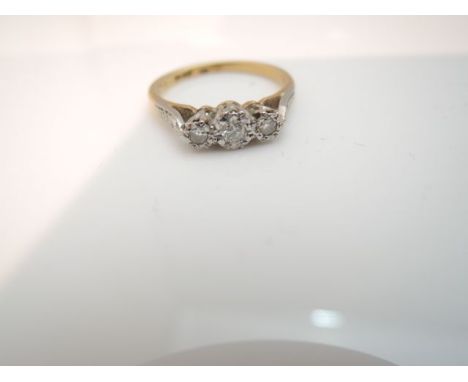 A diamond ring, centred with a round brilliant-cut diamond weighing approximately 0.05cts, flanked to each side with a single