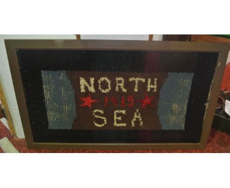 A World War I sailor's wool work rug, the centre panel stating North Sea 1915, flanked by two stars, the outer panels of pale